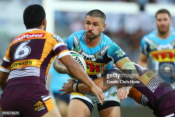 Nathan Peats of the Titans runs the ball during the round 17 NRL match between the Gold Coast Titans and the Brisbane Broncos at Cbus Super Stadium...