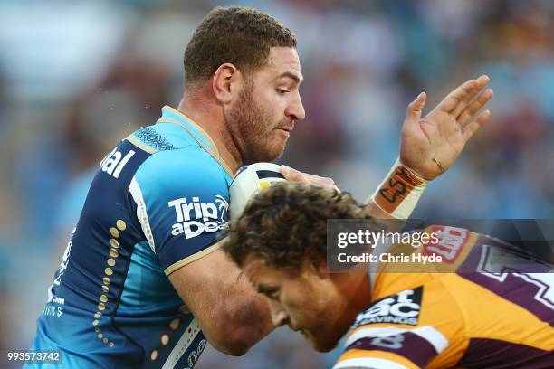 Brenko Lee of the Titans is tackled during the round 17 NRL match between the Gold Coast Titans and the Brisbane Broncos at Cbus Super Stadium on...