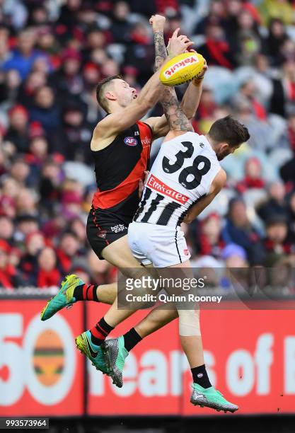 Shaun McKernan of the Bombers marks infront of Jeremy Howe of the Magpies during the round 16 AFL match between the Essendon Bombers and the...