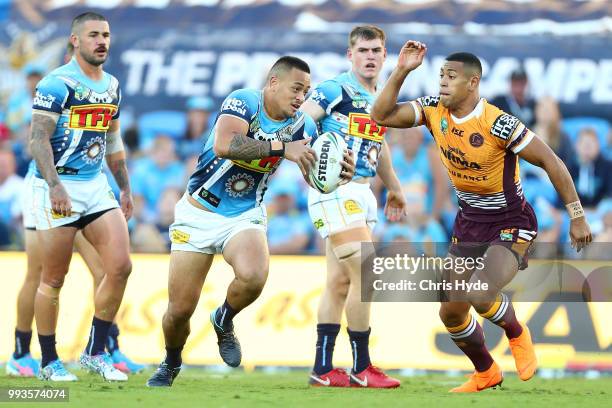 Phillip Sami of the Titans runs the ball during the round 17 NRL match between the Gold Coast Titans and the Brisbane Broncos at Cbus Super Stadium...