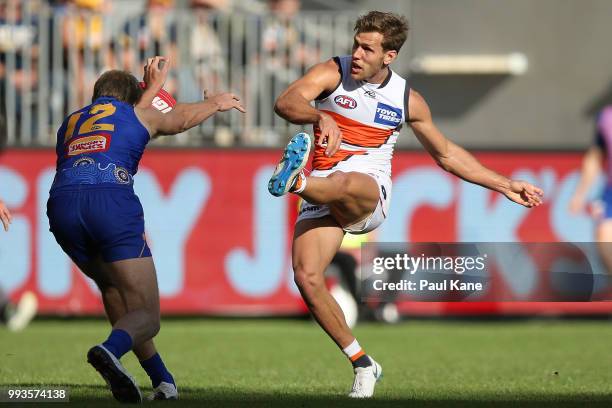 Oscar Allen of the Eagles smothers the kick of Matt de Boer of the Giants during the round 16 AFL match between the West Coast Eagles and the Greater...