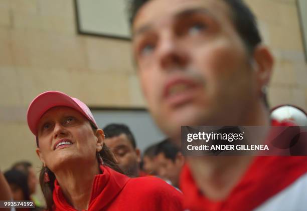 Participants wait before running next to Jose Escolar fighting bulls on the second day of the San Fermin bull run festival in Pamplona, northern...