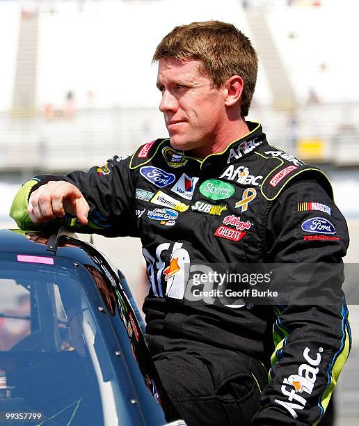 Carl Edwards, driver of the Aflac Ford, gets out of his car after qualifying for the NASCAR Sprint Cup Series Autism Speaks 400 at Dover...