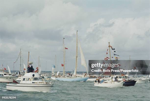 View of the yacht 'British Steel', skippered by Scottish yachtsman Chay Blyth, making its way up the Solent with an escort of small boats at the end...
