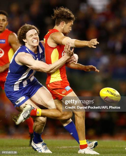 Ben Brown of the Kangaroos tackles Jarrod Harbrow of the Suns during the round 16 AFL match between the North Melbourne Kangaroos and the Gold Coast...