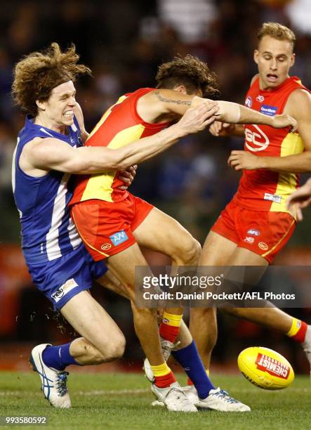 Ben Brown of the Kangaroos tackles Jarrod Harbrow of the Suns during the round 16 AFL match between the North Melbourne Kangaroos and the Gold Coast...