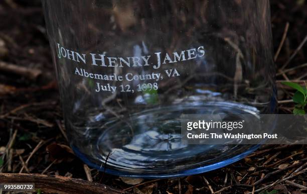 Jar that was later filled with soil from a lynching site near downtown, Charlottesville, Virginia. The name of the victim and the date of the crime...