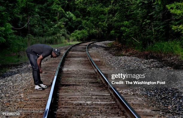 Wes Bellamy, a member of the Charlottesville City Council, has a quiet moment to himself just after he attended a ceremony to acknowledge a lynching...