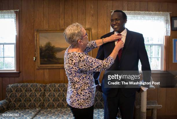 Jill Bethune Wood adjusts Bol Gai Deng's tie in their home June 27, 2018 in Richmond, Va. Deng, who came to the United States around the age of 18...