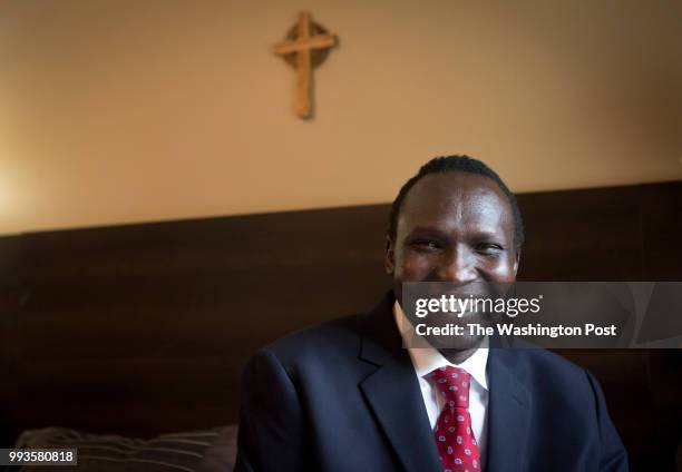 Bol Gai Deng sits in his bedroom in Richmond, Va. June 27, 2018. Deng was enslaved around the age of 7 during the war in Sudan and is one of the...