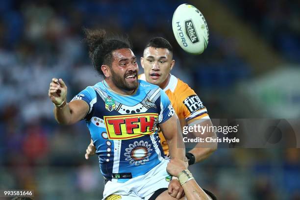 Konrad Hurrell of the Titans passes while tackled during the round 17 NRL match between the Gold Coast Titans and the Brisbane Broncos at Cbus Super...