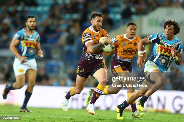 Darius Boyd of the Broncos runs the ball during the round 17 NRL match between the Gold Coast Titans and the Brisbane Broncos at Cbus Super Stadium...