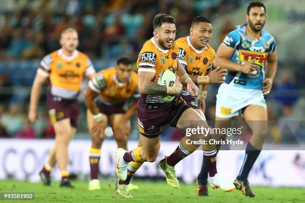 Darius Boyd of the Broncos runs the ball during the round 17 NRL match between the Gold Coast Titans and the Brisbane Broncos at Cbus Super Stadium...