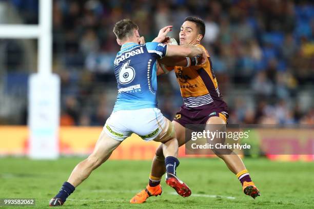 Kodi Nikorima of the Broncos is tackled during the round 17 NRL match between the Gold Coast Titans and the Brisbane Broncos at Cbus Super Stadium on...