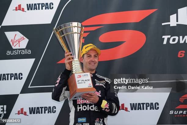 2nd place Jamie Whincup driver of the Red Bull Holden Racing Team Holden Commodore ZB celebrates on the podium during race 18 of the Supercars...