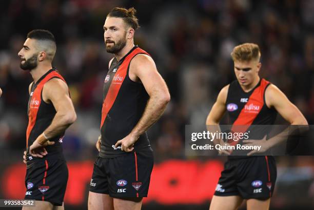 Adam Saad, Tom Bellchambers and Matt Guelfi of the Bombers look dejected after losing the round 16 AFL match between the Essendon Bombers and the...