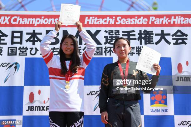 1st place Haruka Seko and 2nd place Ayaka Asahina celebrate on the podium during the Japan National BMX Championships at Hitachinaka Kaihin Park on...