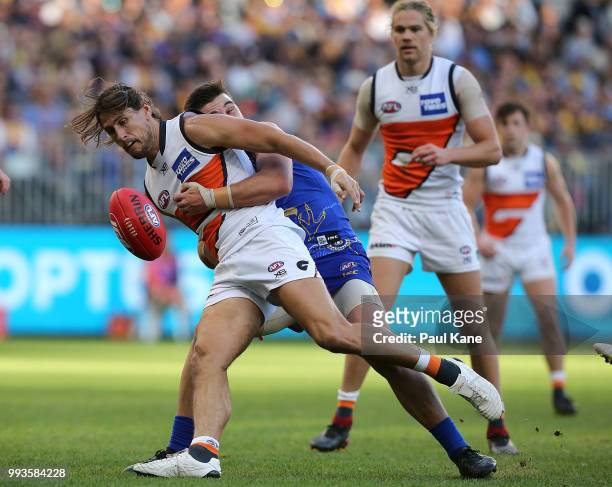 Ryan Griffen of the Giants gets tackled by Elliot Yeo of the Eagles during the round 16 AFL match between the West Coast Eagles and the Greater...