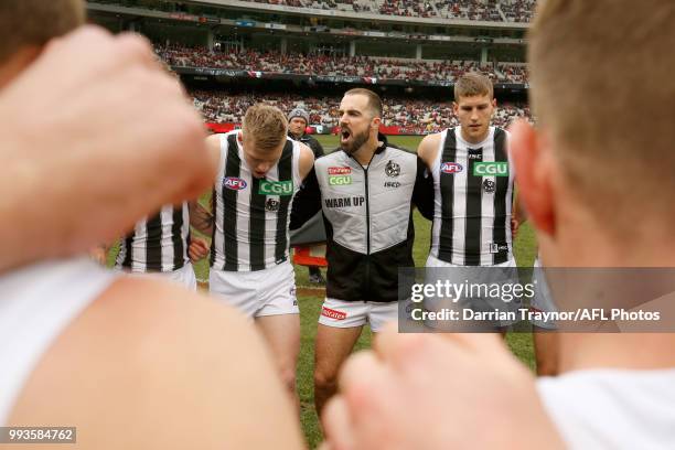 Steele Sidebottom of the Magpies gives team mates some encouragement before the round 16 AFL match between the Essendon Bombers and the Collingwood...