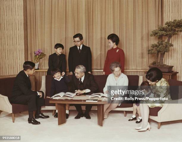 Emperor Hirohito of Japan pictured seated in centre with members of the Imperial family in Tokyo, Japan in December 1971. Family members are, back...
