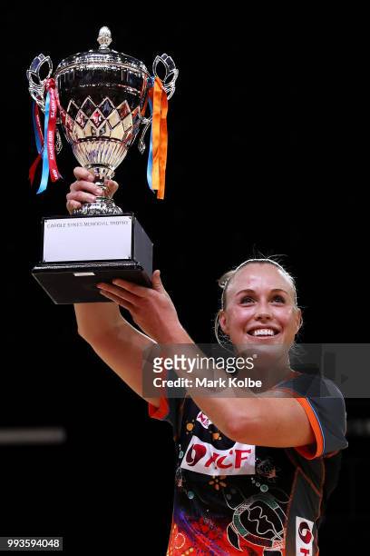 Kimberlee Green of the Giants holds up the Carole Sykes Memorial Trophy after victory during the round 10 Super Netball match between the Giants and...