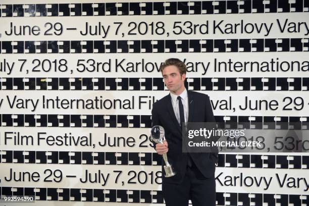 British actor Robert Pattinson poses with the Crystal Globe Prize president's prize during the closing ceremony at the 53rd Karlovy Vary...