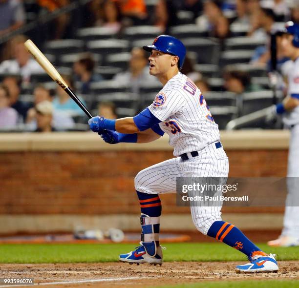 Michael Conforto of the New York Mets follows through on a long fly ball in an MLB baseball game against the Pittsburgh Pirates on June 27, 2018 at...