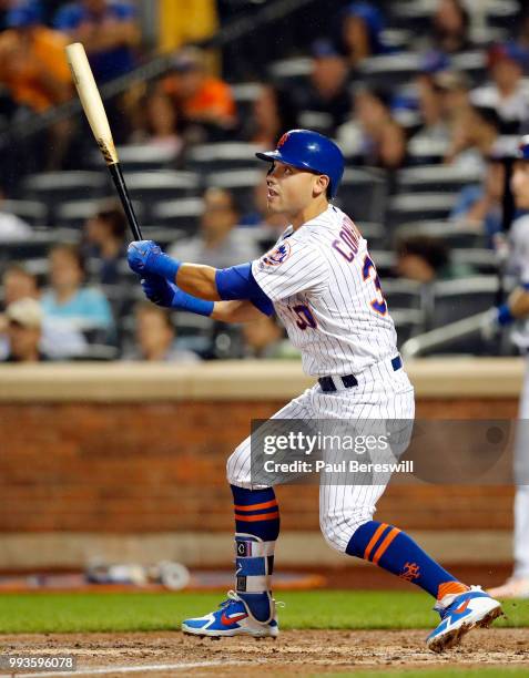 Michael Conforto of the New York Mets follows through on a long fly ball in an MLB baseball game against the Pittsburgh Pirates on June 27, 2018 at...