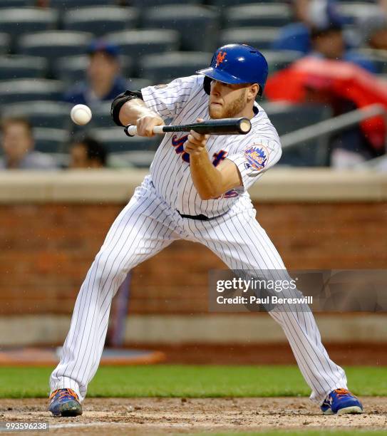 Pitcher Zack Wheeler of the New York Mets lays down a sacrifice bunt in an MLB baseball game against the Pittsburgh Pirates on June 27, 2018 at Citi...