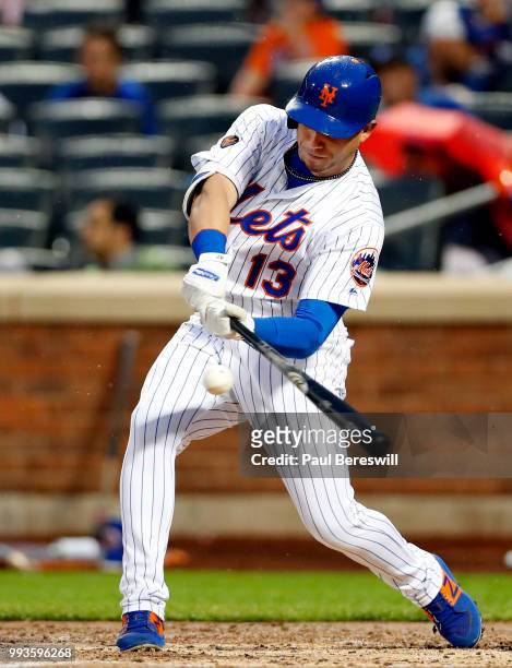 Asdrubal Cabrera of the New York Mets hits an rbi single in an MLB baseball game against the Pittsburgh Pirates on June 27, 2018 at Citi Field in the...