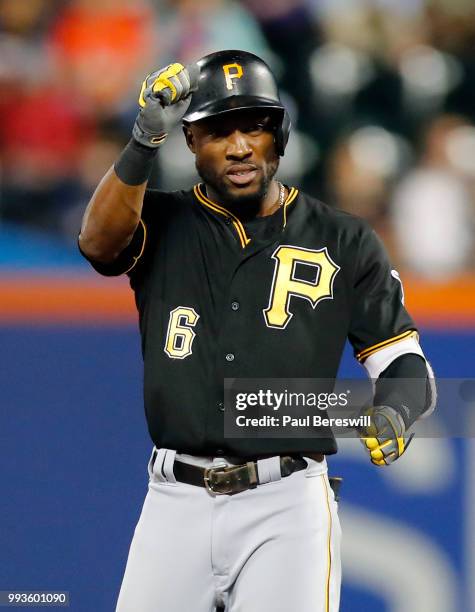 Starling Marte of the Pittsburgh Pirates gestures to teammates in his dugout after hitting a double in an MLB baseball game against the New York Mets...