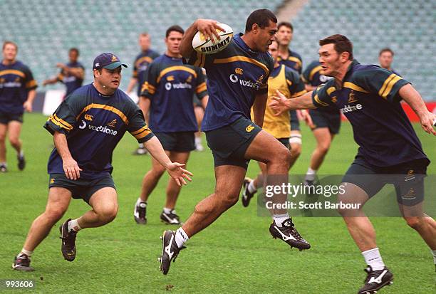 Toutai Kefu of Australia attempts to evade Daniel Herbert of Australia during a light training session at the Sydney Football Stadium, Sydney,...