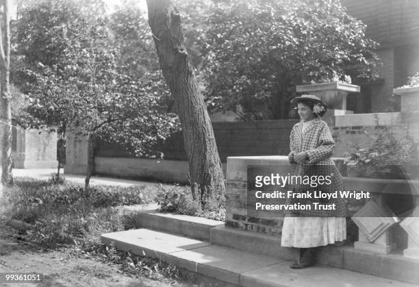 Edith Jasin on sidewalk beside east planter in front of Studio entrance, 1911 renovations visible, at the Frank Lloyd Wright Home and Studio, located...