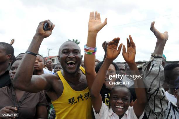 Youths wave to President Goodluck Jonathan upon his arrival in Port Harcourt on May 14, 2010. President Jonathan who is making his first official...