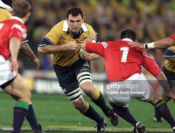 Owen Finegan of Australia on the burst as he is confronted by Tom Smith of the British and Irish Lions during the third Test Match between the...