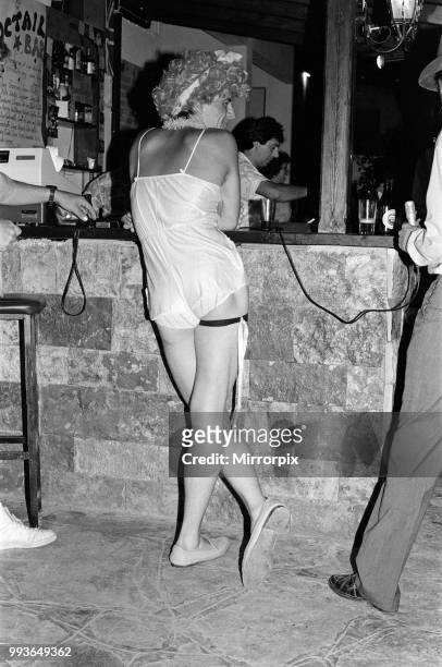 Young people on holiday in Corfu on a Club 18-30 holiday. A contestant for the drag queen contest wait for curtain up. August 1986.