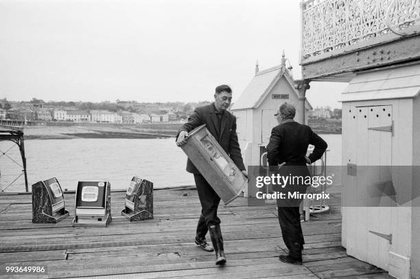 Three one-armed bandits which have been marooned for a weekend at Clevedon, Somerset, were rescued by boat. But four other slot machines had to be...