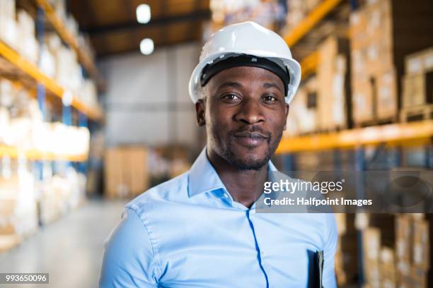 mature man manager or supervisor with smartphone in a warehouse. - neckwear stockfoto's en -beelden