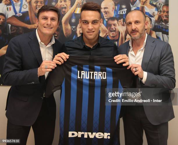 The new signing of FC Internazionale Milano Lautaro Javier Martinez poses with Vice President of FC Internazionale Milano Javier Zanetti and Sportif...