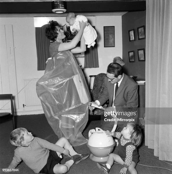 De-compression maternity suit, Linda Evans, with baby Catherine, 8 weeks, and watched by Joanne, 23 months and Rupert 4 years, as husband Neil Evans,...