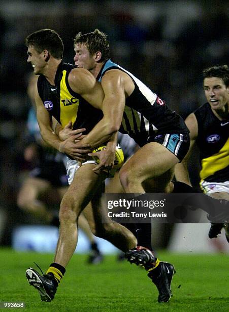 Leon Cameron for Richmond is tackled by Stuart Dew for Port in the match between Port Power and the Richmond Tigers in round 15 of the AFL played at...