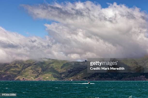 weather approaching in akaroa harbour - banks peninsula foto e immagini stock