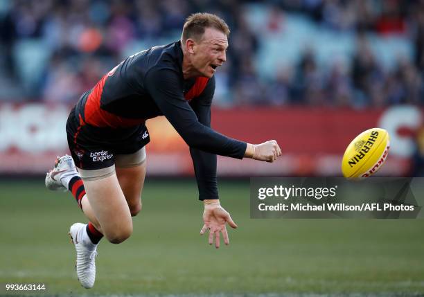 Brendon Goddard of the Bombers handpasses the ball during the 2018 AFL round 16 match between the Essendon Bombers and the Collingwood Magpies at the...