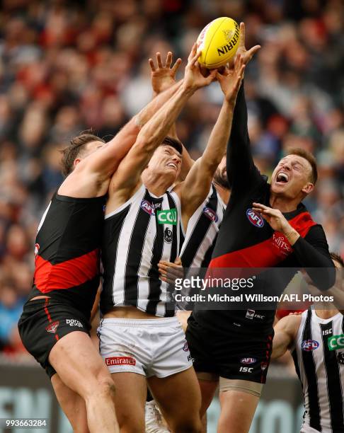 Cale Hooker of the Bombers, Brody Mihocek of the Magpies and Brendon Goddard of the Bombers compete for the ball during the 2018 AFL round 16 match...