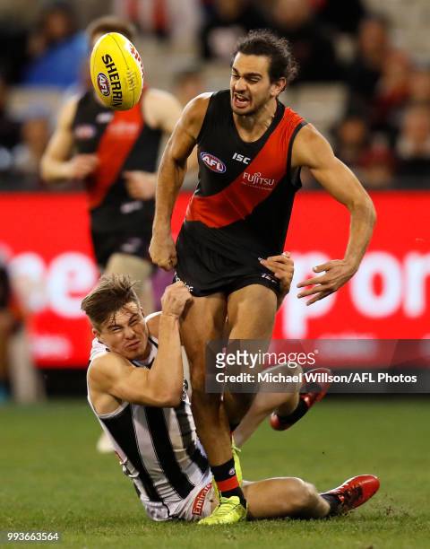Jake Long of the Bombers and Josh Thomas of the Magpies in action during the 2018 AFL round 16 match between the Essendon Bombers and the Collingwood...