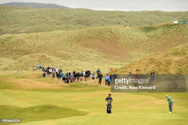Paul Dunne of Ireland hits his second shot on the 9th hole during the final round of the Dubai Duty Free Irish Open at Ballyliffin Golf Club on July...