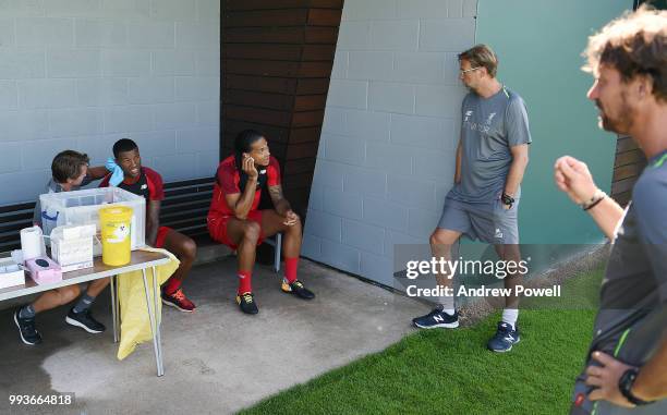 Virgil van Dijk and Georginio Wijnaldum of Liverpool talking with manager of Liverpool Jurgen Klopp during the first day back at Melwood Training...