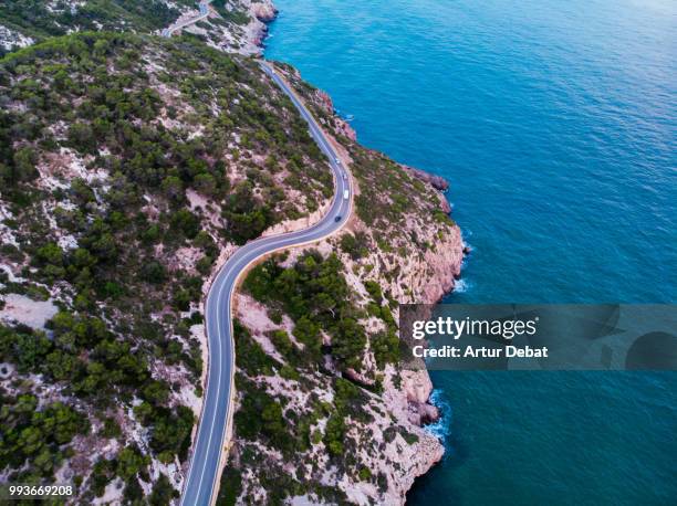 aerial picture taken with drone flying over a traffic road in the coast with cliffs. - debat fotografías e imágenes de stock