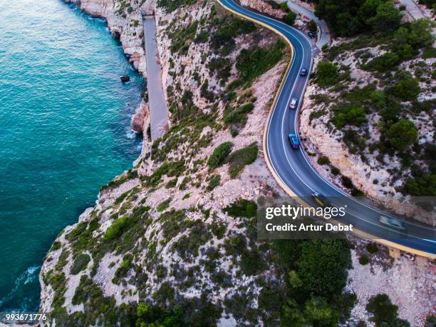 aerial picture taken with drone flying over a traffic road in the coast with cliffs. - debat fotografías e imágenes de stock