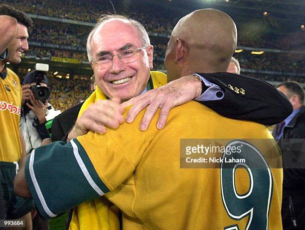 Australian prime minister John Howard hugs George Gregan of the Wallabies after the Wallabies victory over the Lions during the third Test Match...